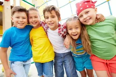 5 kids excited about riding rides at the amusement park