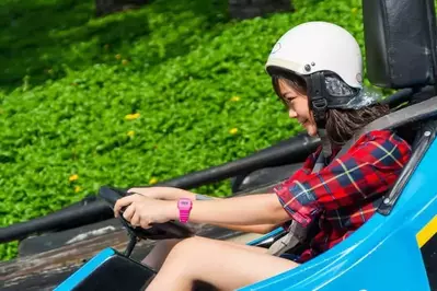 Girl driving a blue go kart