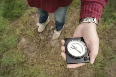 man holding a compass when hiking in the Smoky Mountains