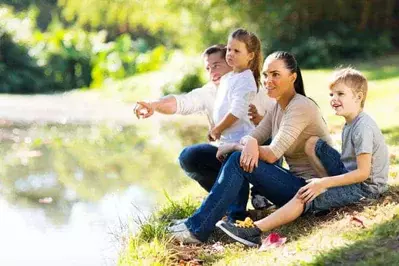family on bank of river