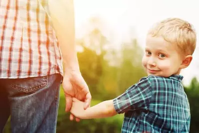 little boy walking with dad