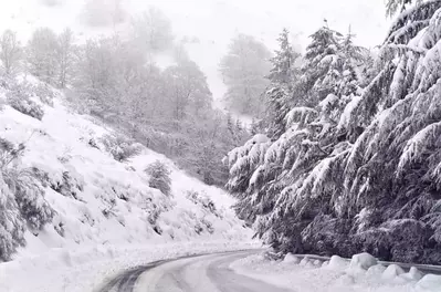 Road covered in snow in the mountains