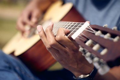 man playing guitar outside