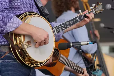 person strumming banjo