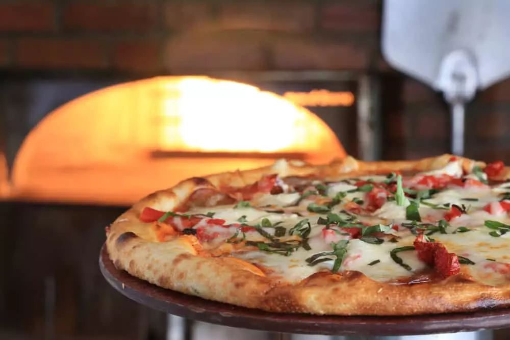 A wood fired pizza just taken from the oven