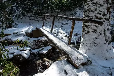 footbridge in the Smoky Mountains covered in snow