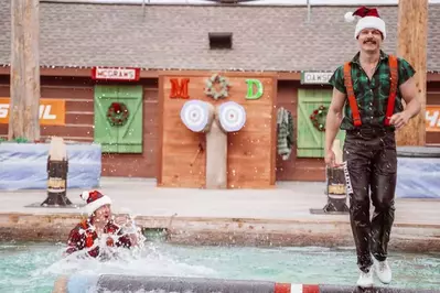 lumberjack smiling after winning log roll