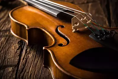old violin on wooden background