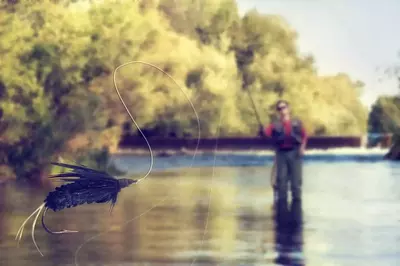 man casting line to fish