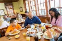 family at table at applewood farmhouse