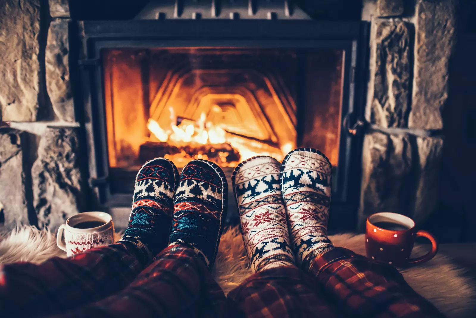 couple laying by the fireplace