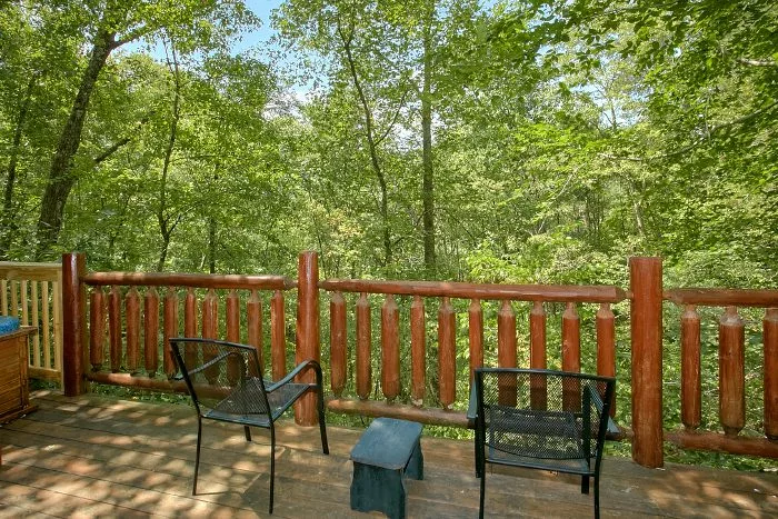 Back deck area with chairs next to the hot tub