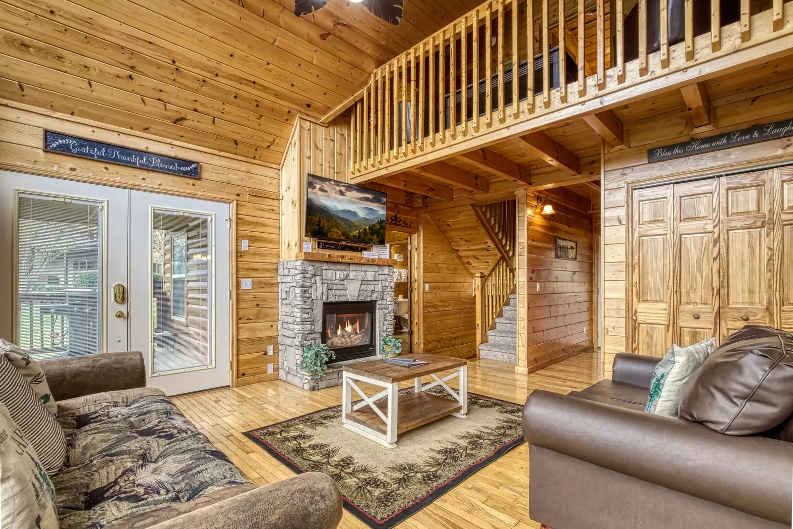Amazing Grace living room with stone encased gas fireplace
