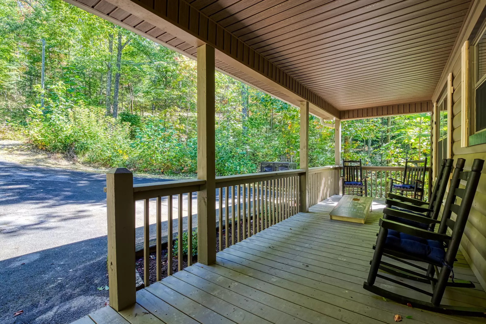 Honeymoon Hideaway covered entry deck with rocking chairs