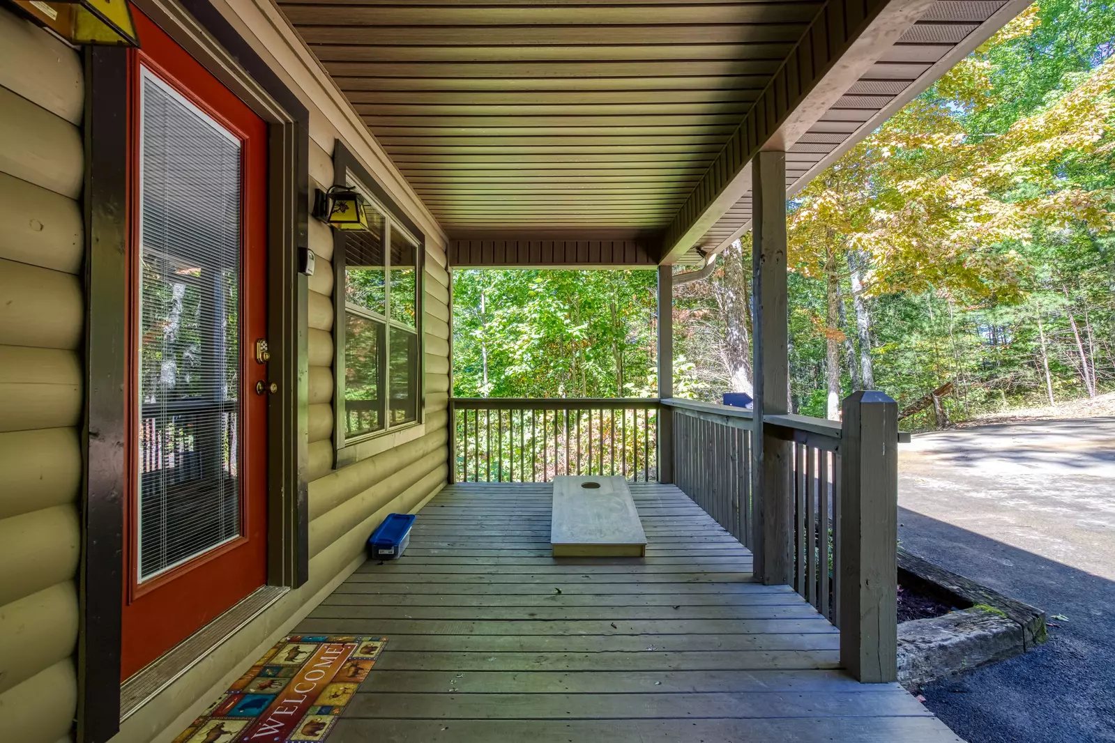 Honeymoon Hideaway covered entry deck with corn hole