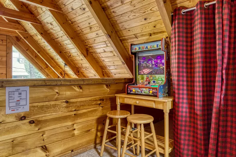 Honey Dreams loft area with arcade game