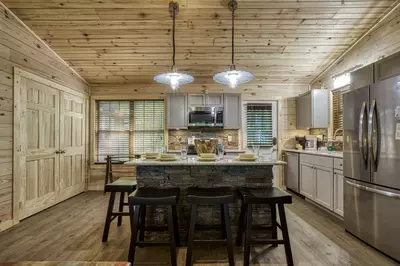 Little Piece of Heaven - Kitchen island and fully furnished kitchen with stainless steel appliances
