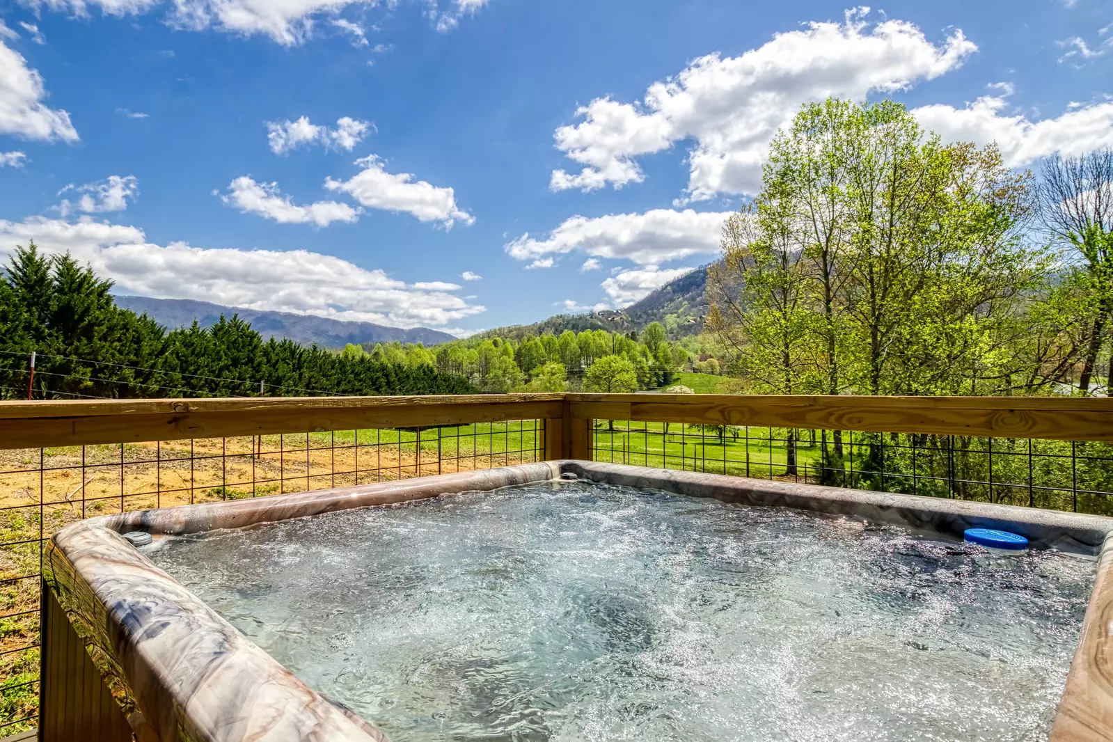 Happy Hollow Hideaway hot tub with mountain views