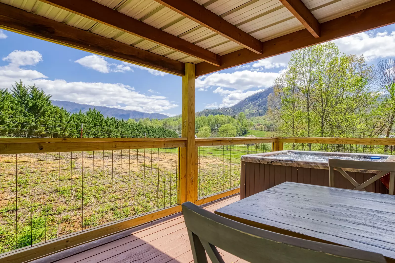 Happy Hollow Hideaway covered back deck with mountain views