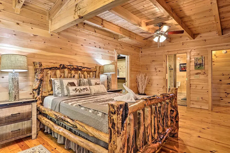 Main level Master bedroom with a large sitting area across the bed.
