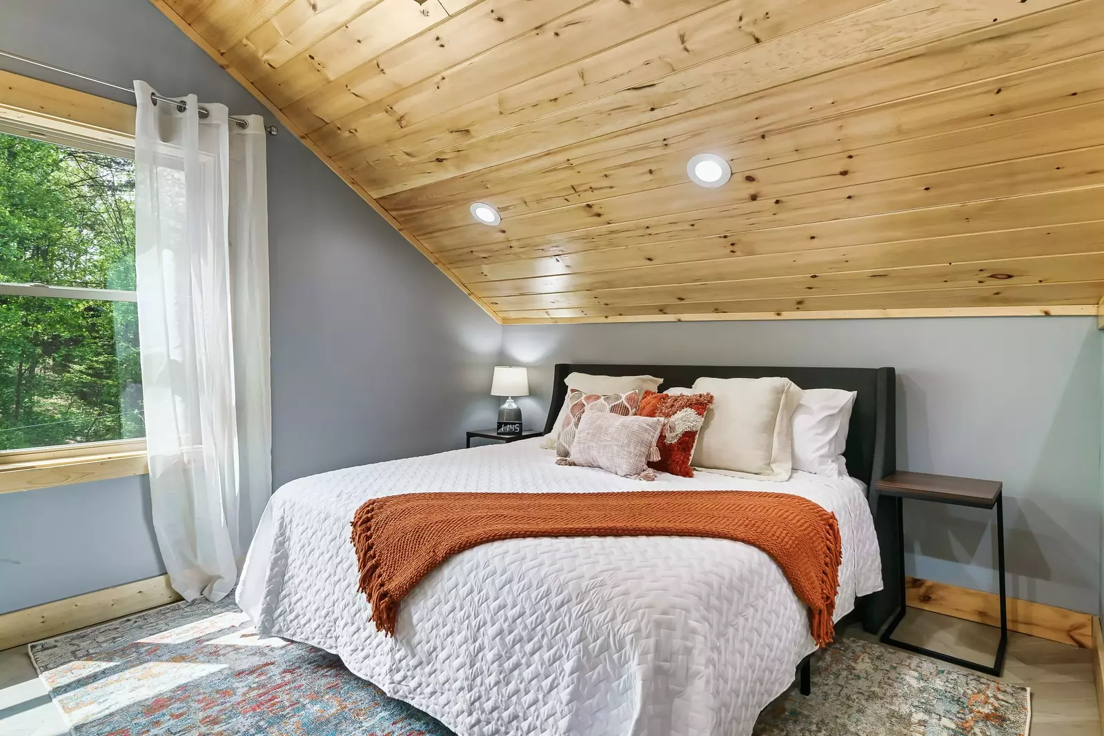 King bed in the loft at the top of the stairs.