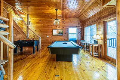 Lower level game room - hot tub is just through the doors on the lower level deck