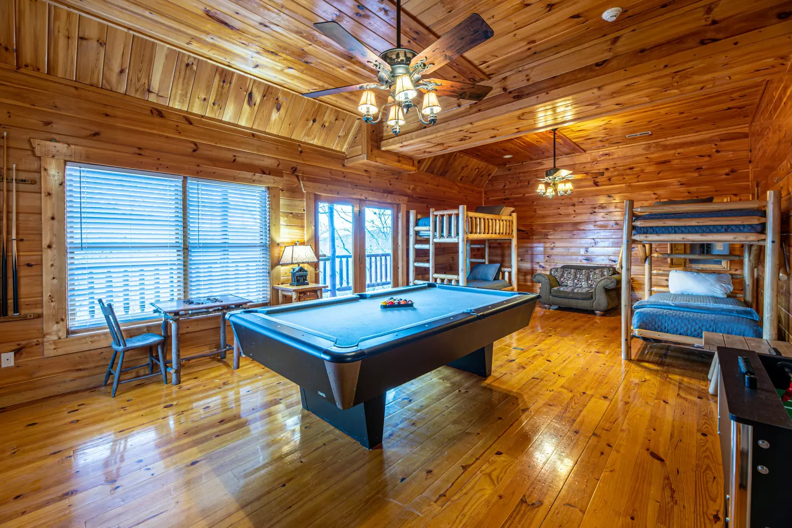 Lower level game room with pool table, foosball, and 2 twin bunk beds