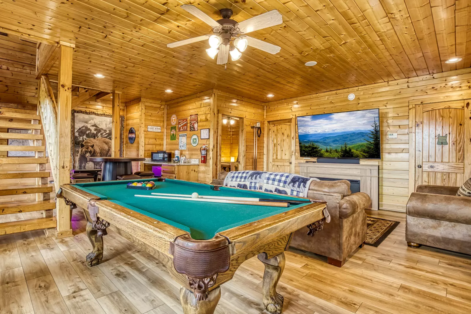 Awesome Views lower level game room with pool table, 75 inch TV, and cocktail style arcade game