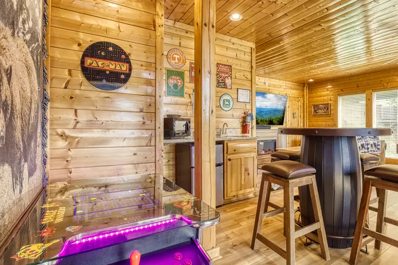 Awesome Views lower level game room with cocktail style arcade game, kitchenette, and 75 inch TV